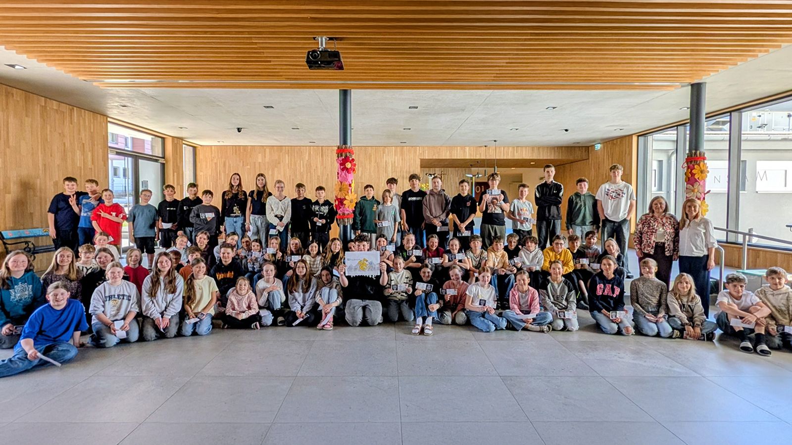 Teilnehmende Schülerinnen und Schüler des Drachentaler-Zeichenwettbewerbs im Foyer der MMS Wildschönau